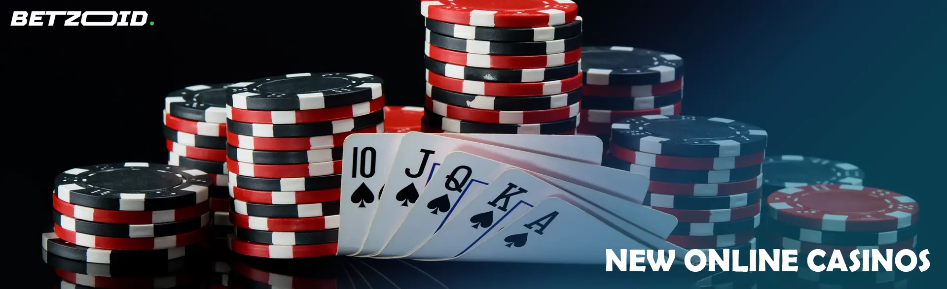 A pile of chips and cards on a dark background.