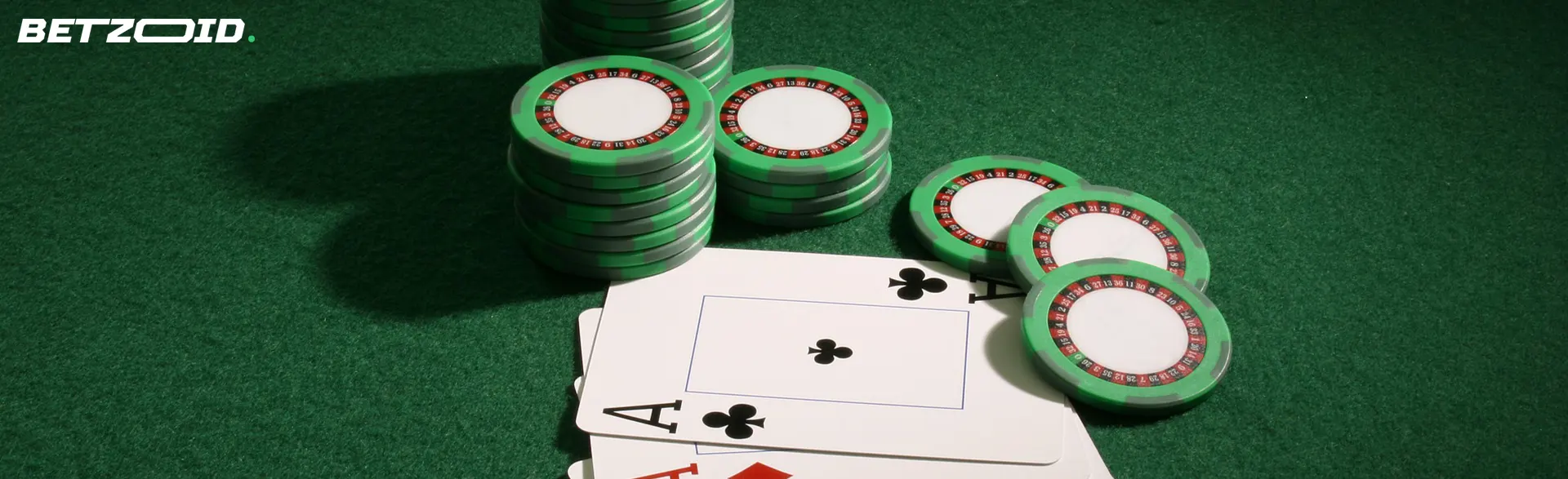 Cards and chips on a green table.
