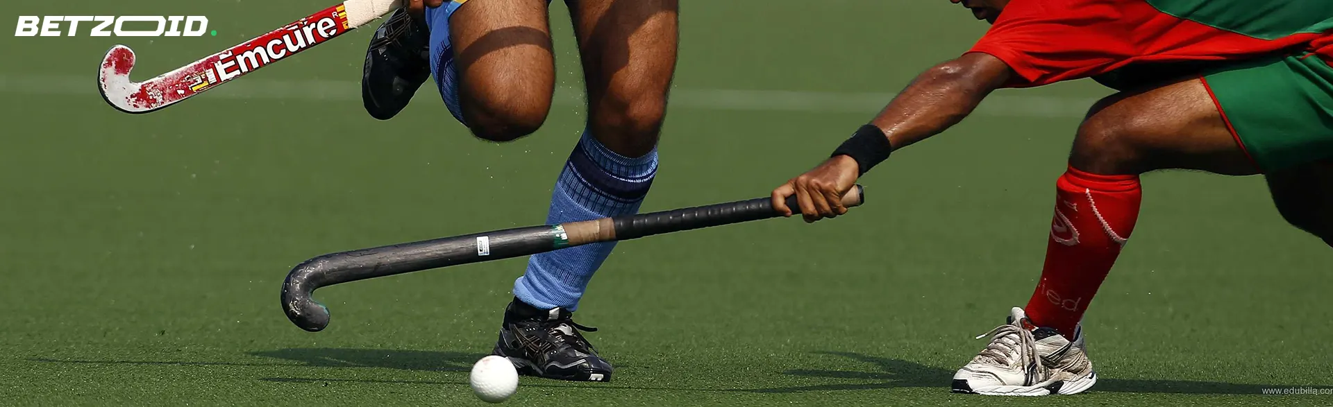 Field hockey players in action during a game.