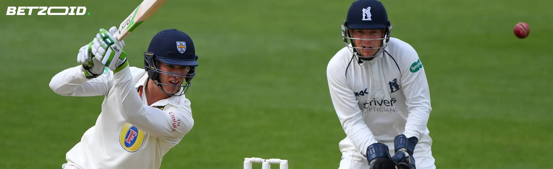 Cricketers in action during a game.