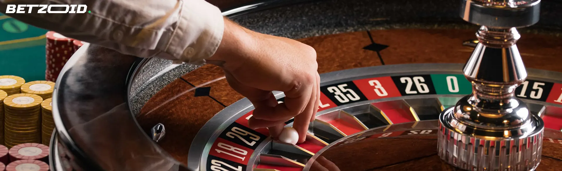 A hand placing a roulette ball on a spinning wheel, capturing the excitement of gaming at New Brunswick casinos.