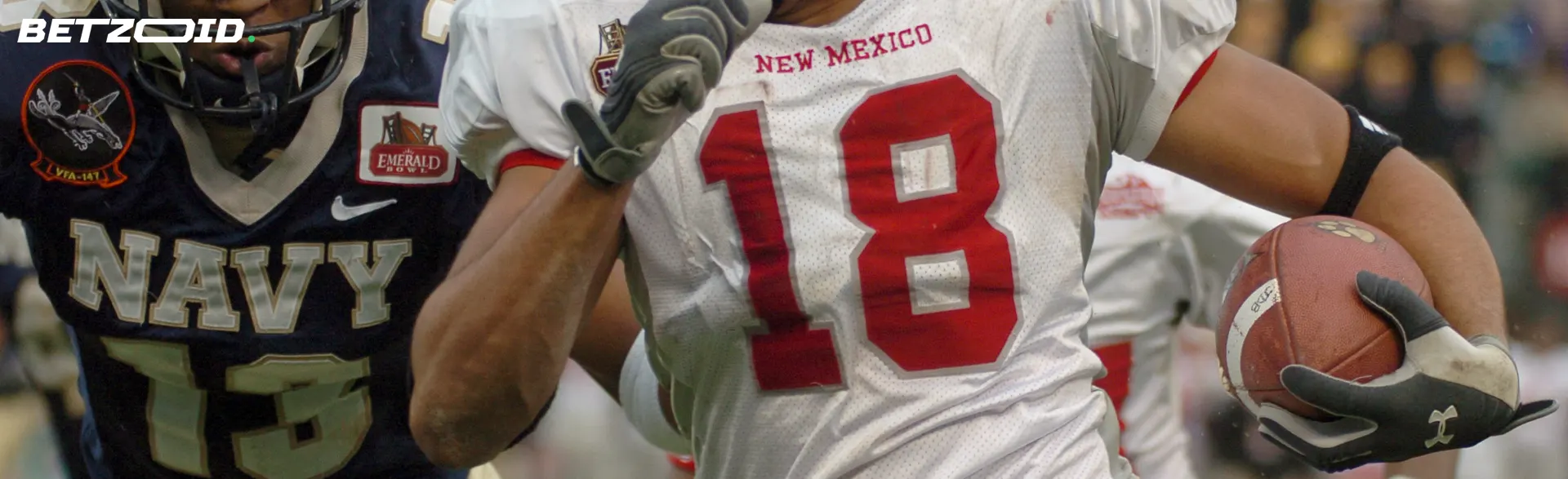 American football players fight for the ball during the game.