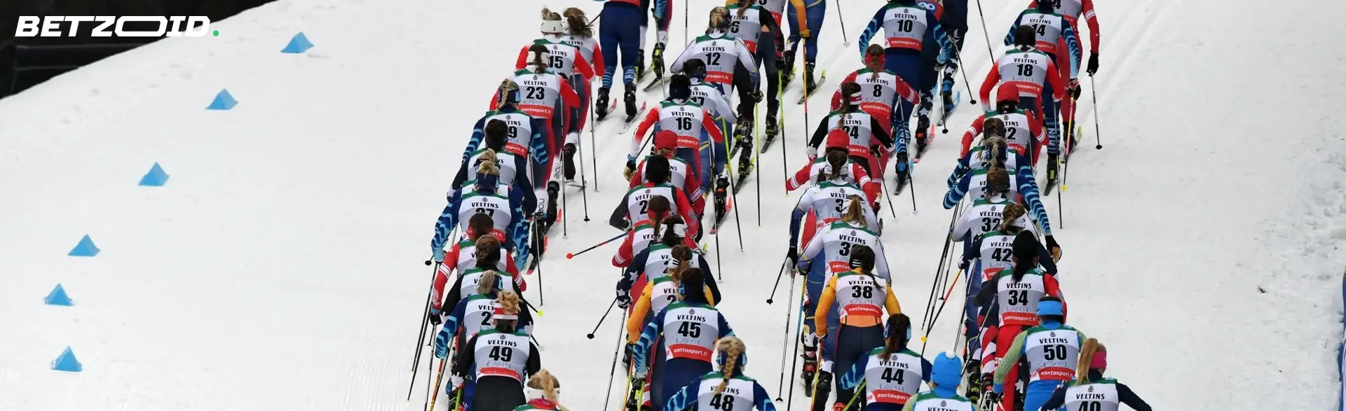 En gruppe skiløpere deltar i en fellesstart i en snødekt bakke.