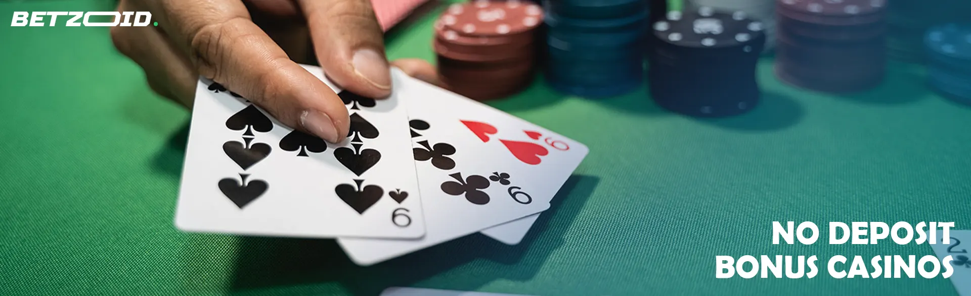 A player holds cards on a casino table.