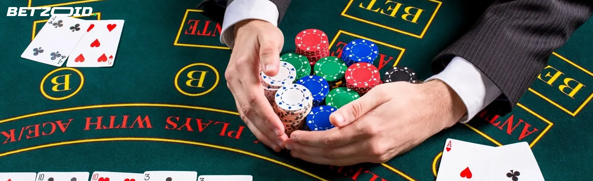 A player is holding a pile of chips on a casino table.