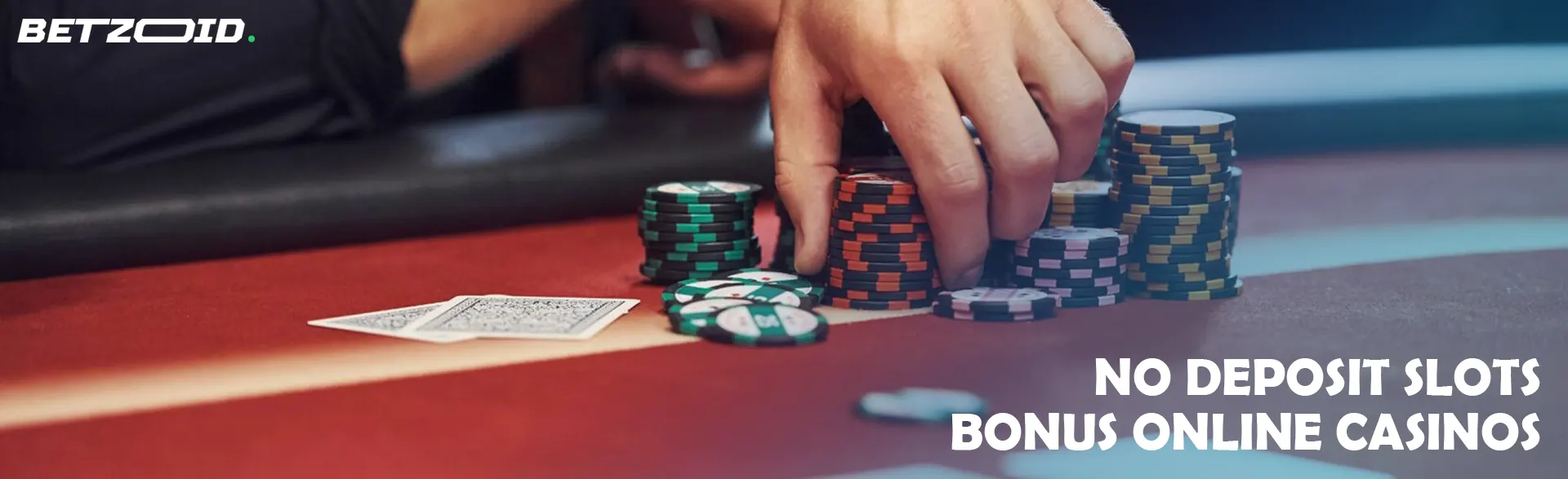 A player holds chips on the casino table.