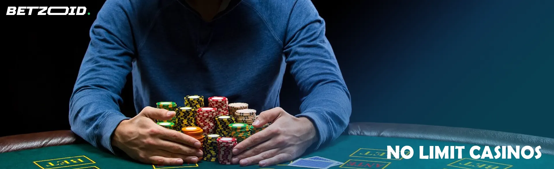 A player is holding a pile of chips on a casino table.