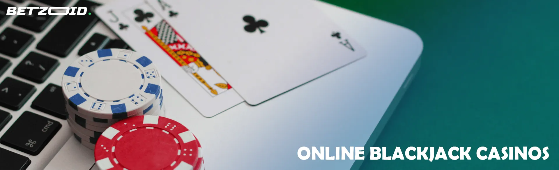 Casino cards and chips on laptop keyboard.