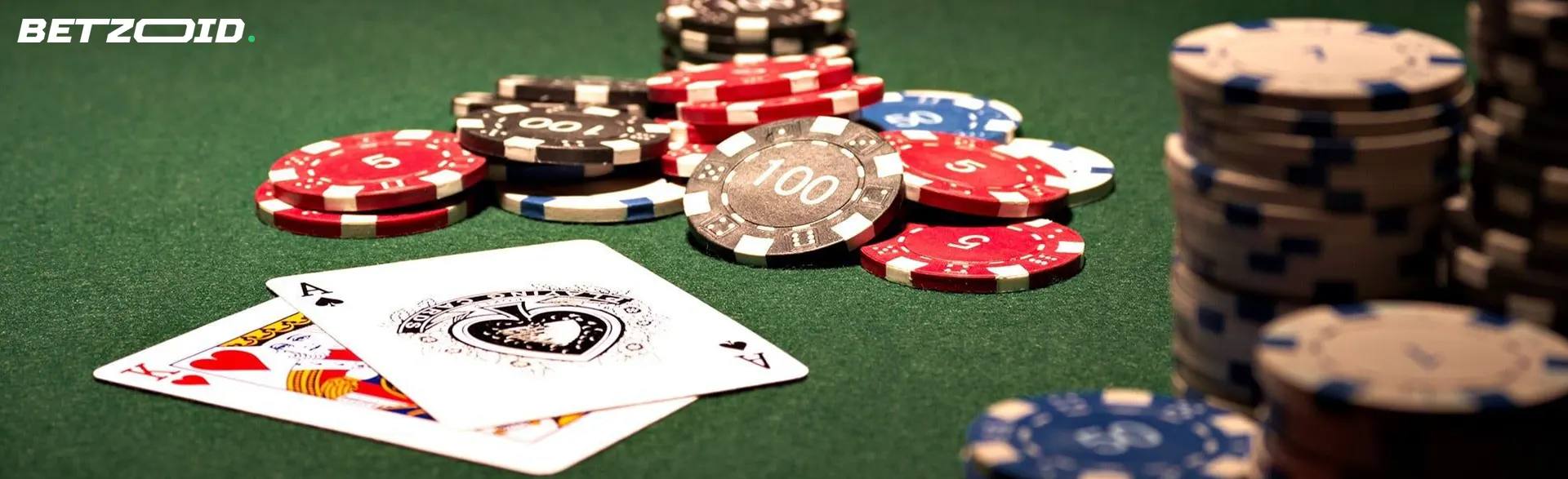 Pile of chips and cards on the casino table.
