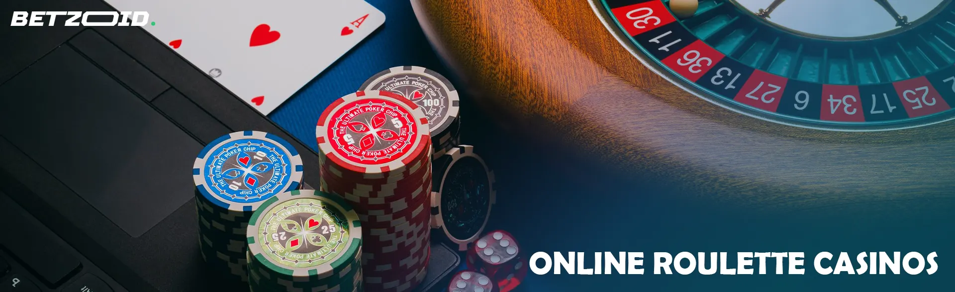 Roulette wheel and cards next to casino chips on laptop.