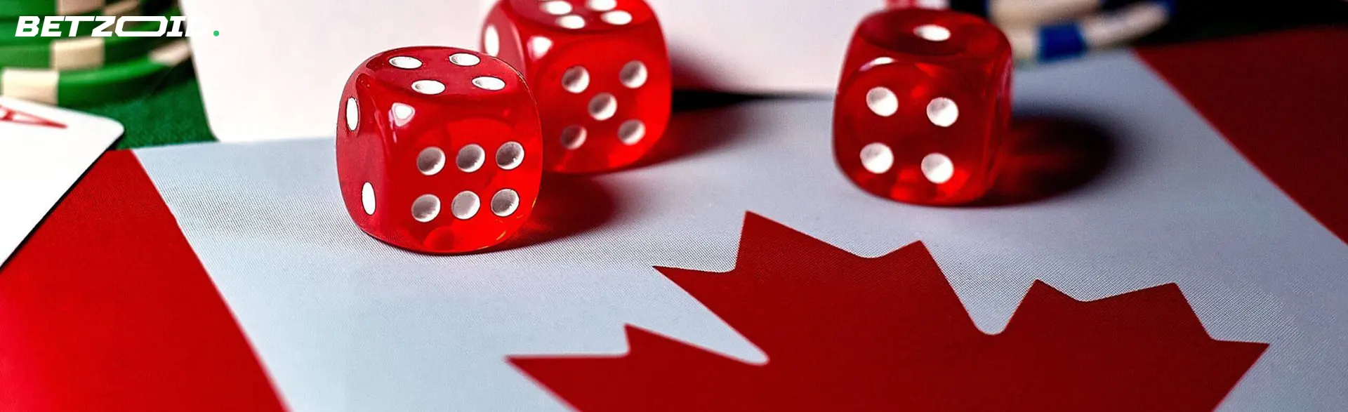 Playing dice, cards and chips on the background of the flag of Canada.