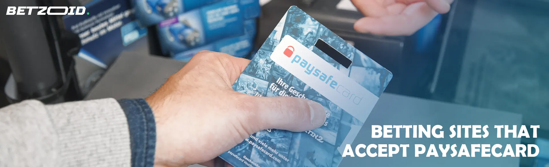 A hand holding a Paysafecard used for payment.