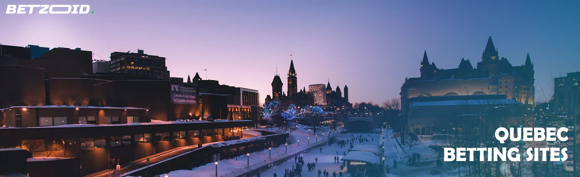 Scenic evening view of Quebec cityscape with illuminated buildings, representing Quebec sportsbooks.
