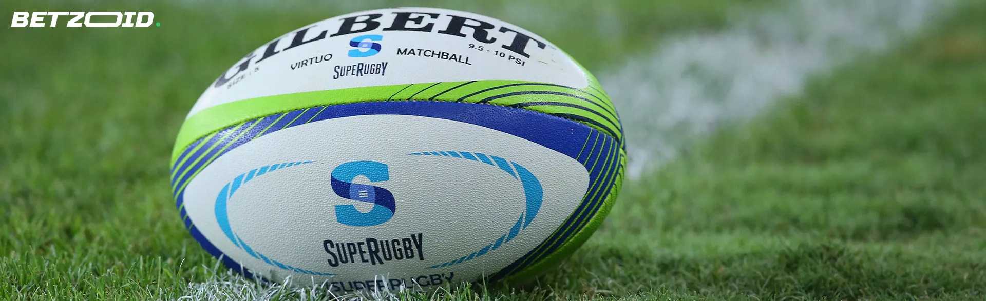 A rugby ball lies on the grass.
