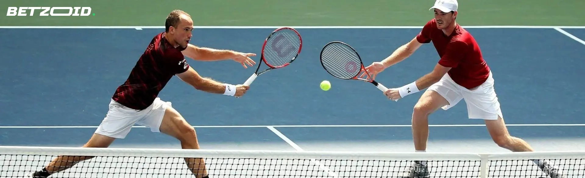 Dos tenistas juegan un partido de dobles en la cancha.