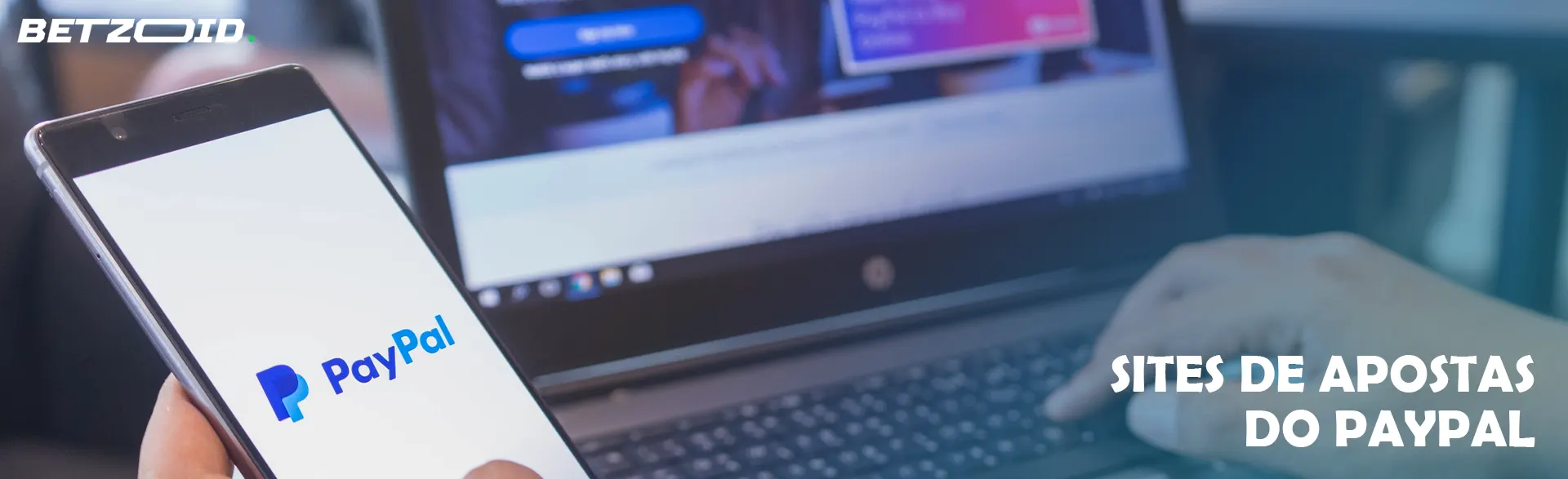 Smartphone com logotipo do PayPal ao lado do laptop.