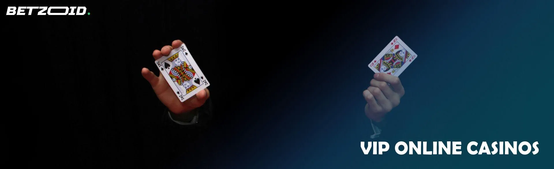 A man is holding two cards on a dark background.