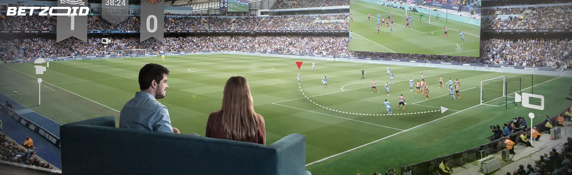 People sitting on the couch watching the match at the stadium.