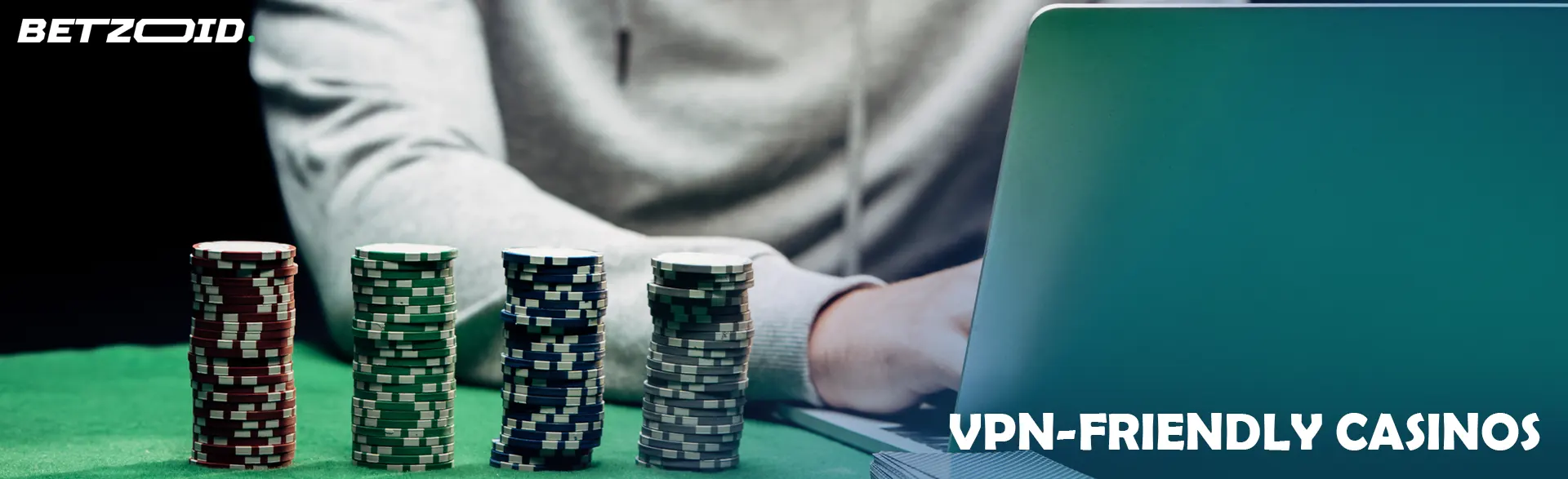 A gambler at a laptop next to casino chips.