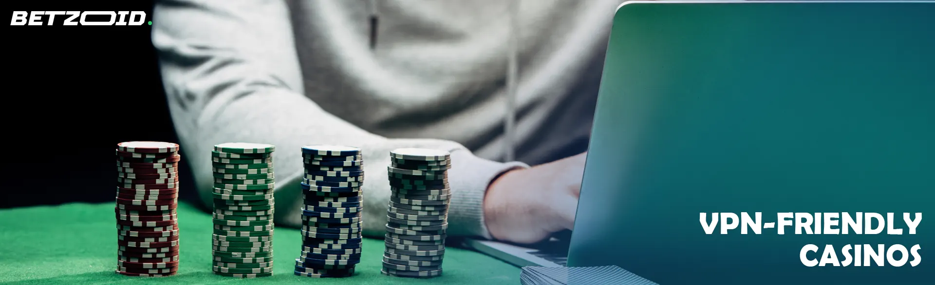 The player is sitting in front of the laptop next to the casino chips.